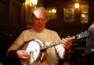 Dessie Mulkere (Clare) playing banjo at Cruises Bar Thurs night seisiún. Photographer Patrick Keating